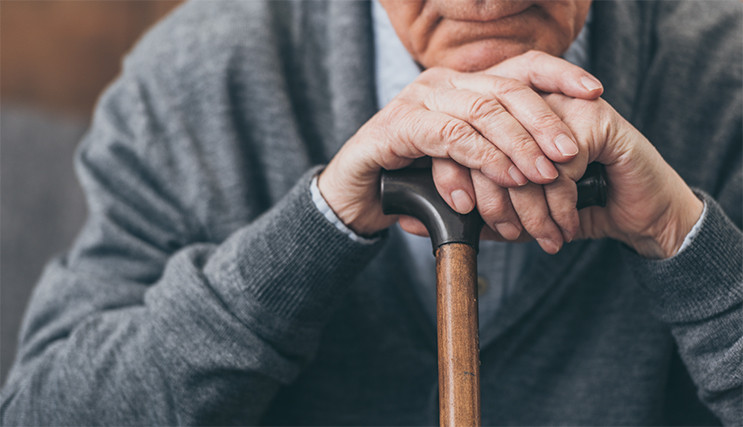 Man resting with a walking stick